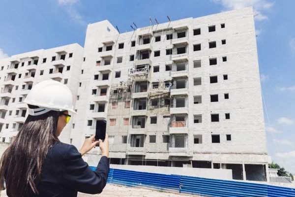 african-american-lady-safety-helmet-taking-photo-building-construction