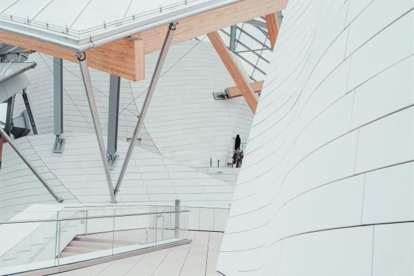 A white business center with beautiful textures and a unique design with interior staircases